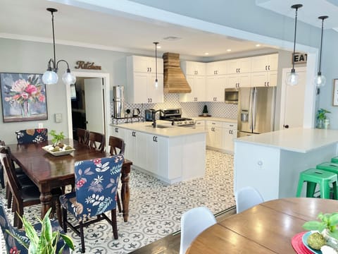 Kitchen has plenty of counter top space and a bar area.