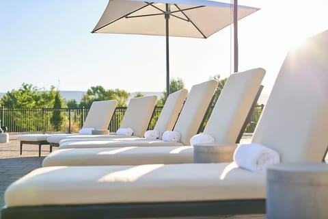 Soak up sunshine on cushioned loungers with fresh rolled towels