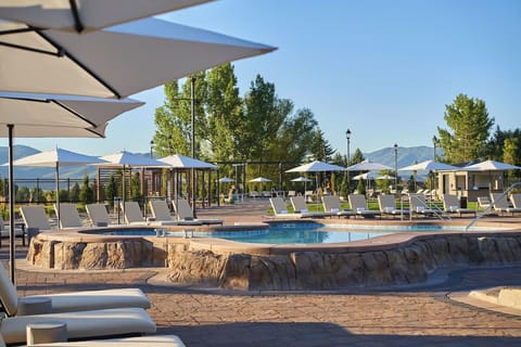 Unwind poolside with shaded seating and warm evening light.