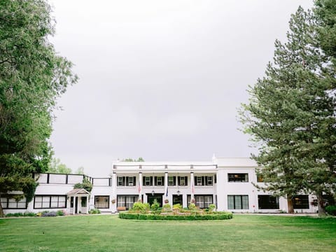 Arrive to a grand estate framed by lush lawns.