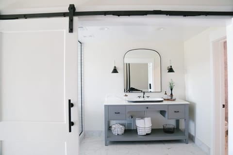 Refresh your routine at a sleek double vanity with bright lighting.