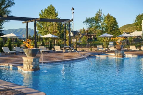 Dive into sparkling resort pools with mountain-view serenity.