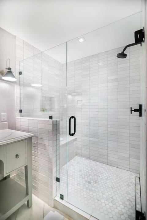 Refresh under a rainfall shower in bright, spotless tile.