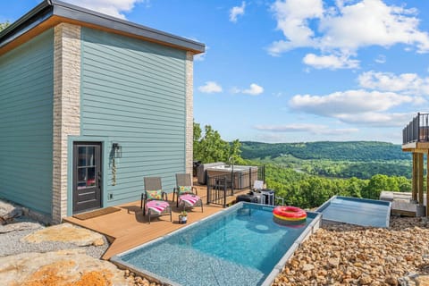 Soak up the breathtaking Ozark Mountain views from the deck and pool at this Branson vacation home by Relax and Renew Rentals. Enjoy your private plunge pool, hot tub and stylish patio seating—perfect for relaxing in Silver Dollar City or Table Rock Lake!