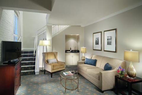 Gather in the spacious living area with stylish stairway backdrop.