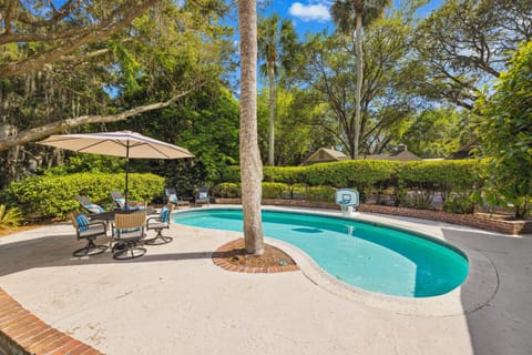 Backyard oasis, complete with a sparkling kidney-shaped pool and generous patio space for lounging and outdoor entertaining.