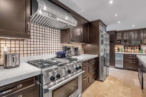 Cook with ease in this fully equipped kitchen, featuring stainless steel appliances, ample counter space, and everything you need to prepare meals that bring everyone together.