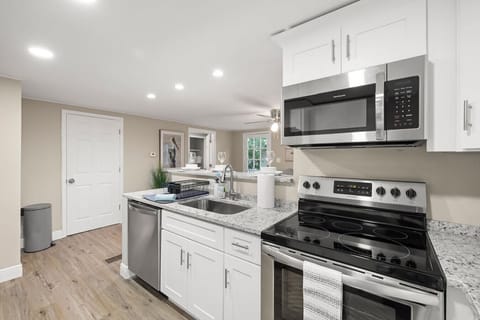 Sleek design meets convenience in this modern kitchen—perfect for a quick snack or a gourmet meal.