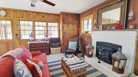 Living room with front screen porch beyond