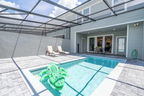 Unwind in your private screened patio with a sparkling pool, comfy loungers, and a playful float-perfect for sunny days and al fresco dining!