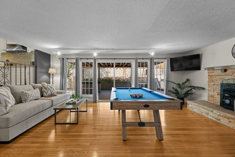 The ultimate hangout spot! This bright and stylish game room features a pool table, fireplace, smart TV, and comfy seating—perfect for relaxing, entertaining, or a little friendly competition.