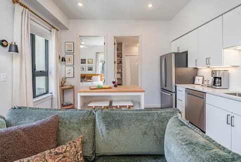 Unit 1: Living Room with a cozy, stylish sofa and music-inspired decor, creating the perfect spot to relax and unwind after a day in Nashville.