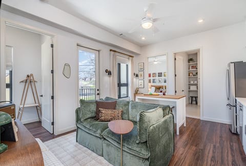 Unit 1: Living Room with a cozy, stylish sofa and music-inspired decor, creating the perfect spot to relax and unwind after a day in Nashville.