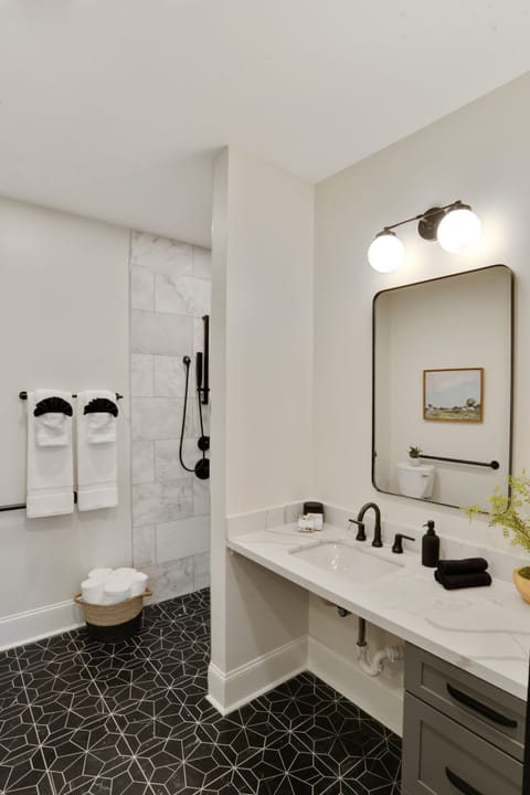 Unit 101 | Bathroom 1 | Full Bathroom | Ensuite to Bedroom 1 | ADA-Compliant Design | Zero-Step Shower | First Floor