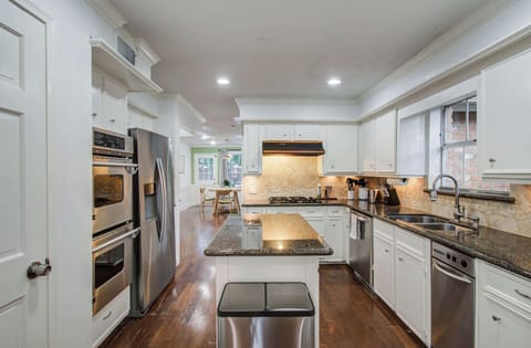 Spacious and grand with plenty of counter space, a center kitchen island, and double ovens, this kitchen has everything you need to whip up a southern feast!