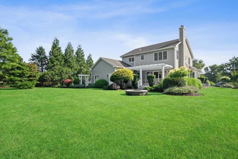 Large private backyard with stone firepit