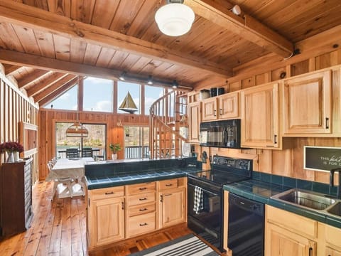 The chalet kitchen is the heart of the home, combining rustic charm with modern convenience. Rich wooden cabinets, their surfaces weathered to perfection, line the walls, offering plenty of storage and a touch of timeless elegance. The countertops are per