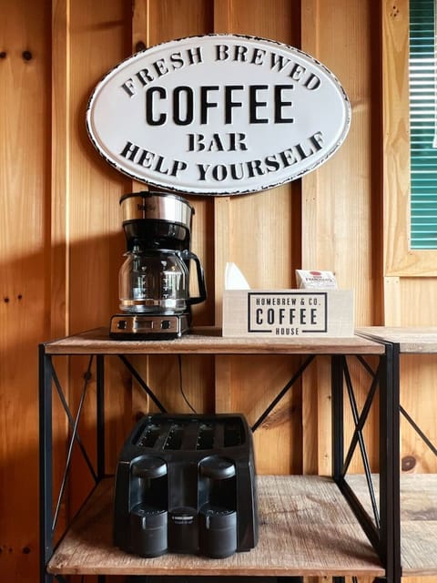 Start your morning with flavor at the fully stocked coffee bar, featuring a coffee pot, a variety of coffee and tea selections, an assortment of creamers, and a collection of stylish mugs.