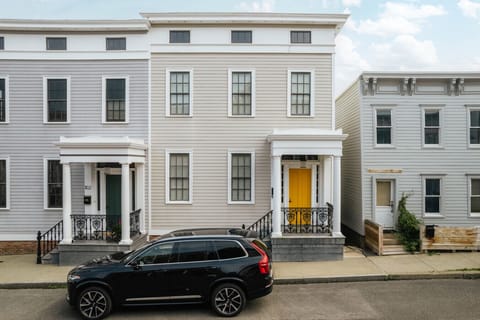 Classic facade with bold charm and a bright yellow door.