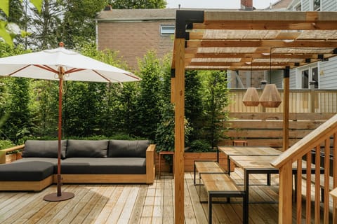 Outdoor lounge area under a charming wooden pergola.