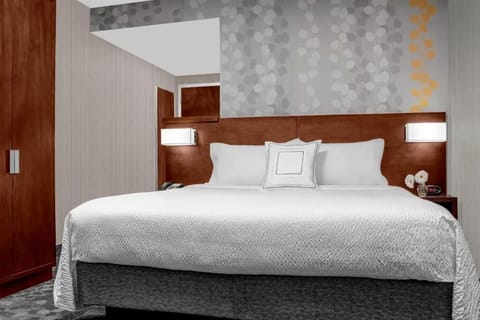 Drift off in a plush king bed under soft lighting.