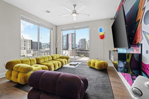- Spacious living room with city views  
- Modern lounge seating for relaxing stays  
- Vibrant mural adds bold Nashville style  