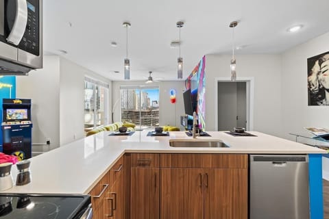 - Open kitchen with wood cabinetry  
- Modern lighting and large island  
- Perfect for cooking and gathering  