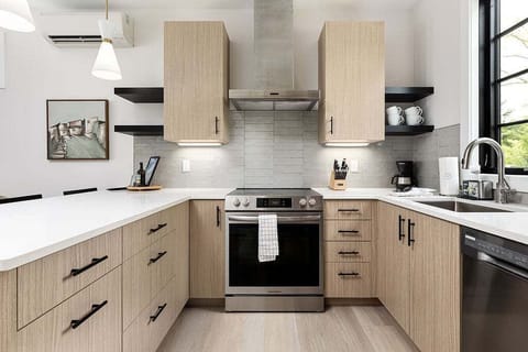 Whip up your favorite meals in this bright, fully-stocked kitchen with modern appliances and an open, airy layout perfect for gathering