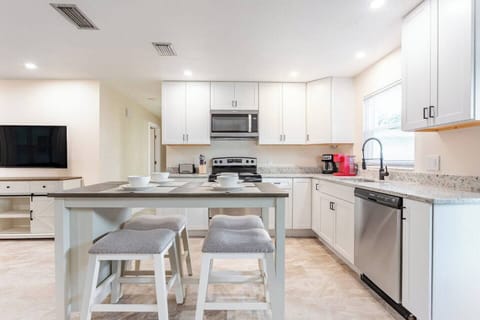 Full kitchen with microwave, range, dishwasher and breakfast bar seating 4