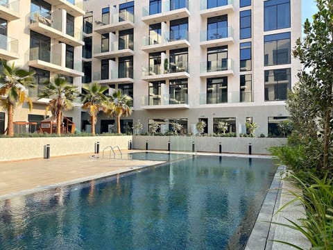 Outdoor: Dive into relaxation with a stunning pool surrounded by lush palm trees!