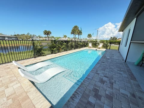 Relaxing pool patio, patio set, built in grill overlooking calm canal & sunsets