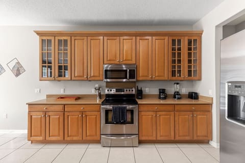 Kitchen | Fully equipped with stainless steel appliances, ample cabinetry, and countertop space