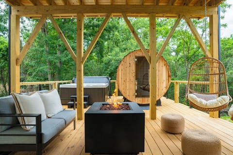 Unwind on the back deck with a 6-person hot tub, barrel sauna, and fire pit.