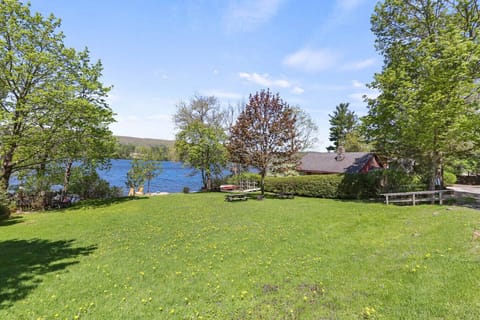 Open green space leading down to the water, ideal for picnics or outdoor games.