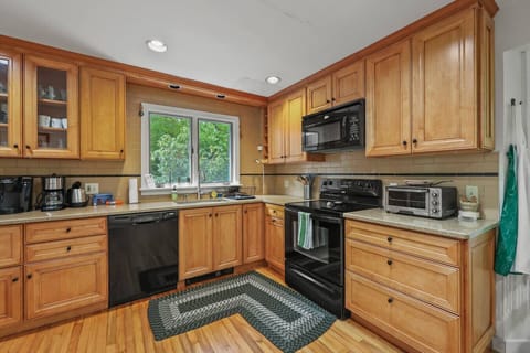 Full kitchen with stainless steel appliances, microwave, oven, and everything you need to cook like home.