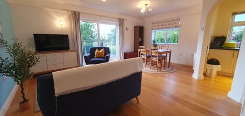 Living and dining room with sliding doors to deck and private garden.