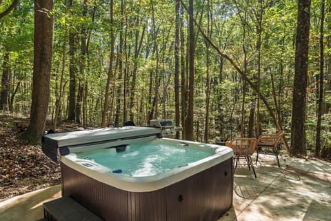 Unwind together in your personal hot tub, nestled against natural rock and surrounded by peaceful woods—the perfect couple’s escape.