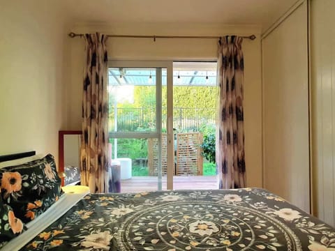Garden View queen room with access to the covered deck and garden space 