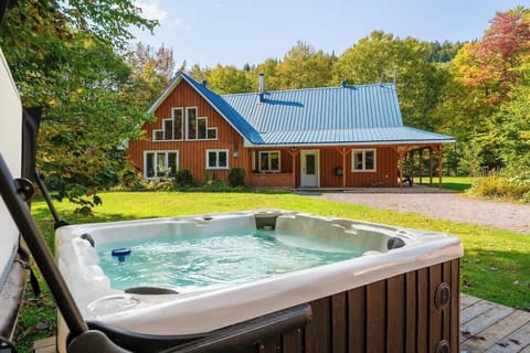 Relax in the outdoor hot tub surrounded by nature and peaceful woodland views