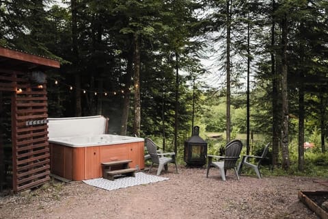 Relaxing outdoor space with a hot tub and seating area, ideal for evenings under the stars.