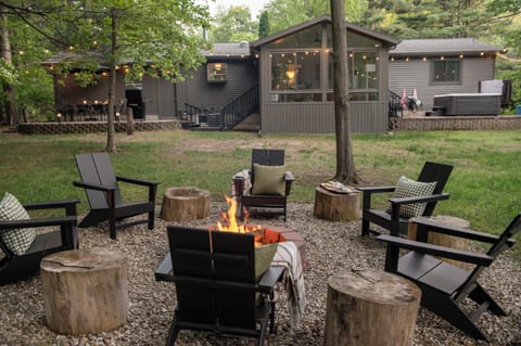 Enjoy the quiet, wooded backyard retreat with fire pit, hammock, patio, and private hot tub.
