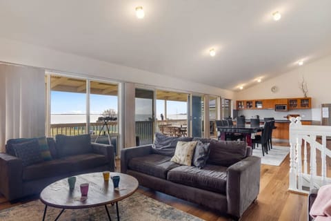 Settle into the main living room upstairs, where generous seating and river outlooks make it easy to slow the pace of the day.