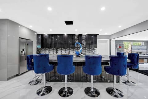 Modern kitchen with marble island and bar seating for eight.