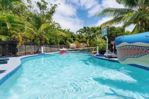 Spacious private pool with volleyball net and toys.