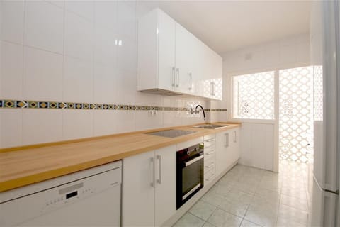 Bright kitchen in this apartment is fully equipped with all the appliances