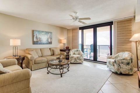 Open-concept living room with Gulf views and tile flooring at Wind Drift Orange Beach