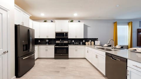 Modern kitchen with sleek appliances, ample counter space, and bright design