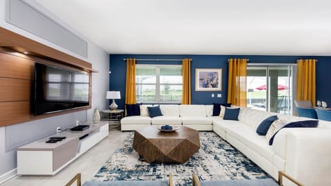 Modern living room with a large TV, cozy sectional, and elegant design