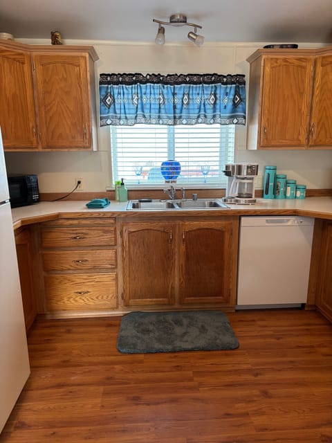 Beautiful view out the window. Coffee pot, toaster, microwave, & new dishwasher.