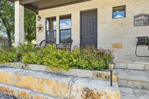 Relax on the charming stone porch, surrounded by colorful blooms and Hill Country charm.